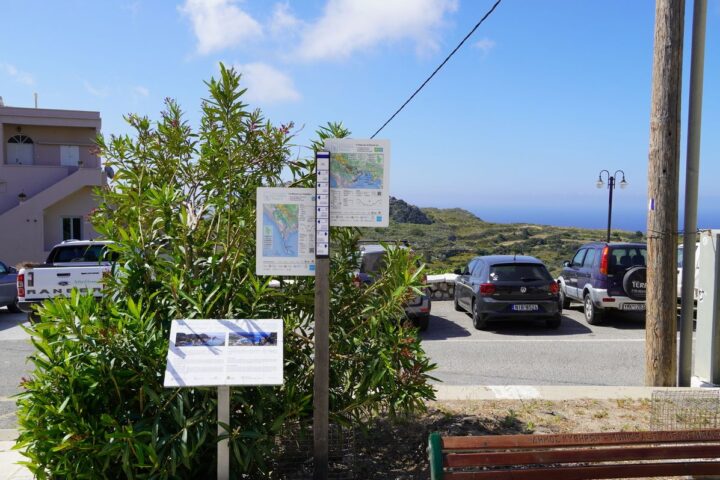 A double trailhead sign in Chora, Kythera, with a Friendship Trail board next to it