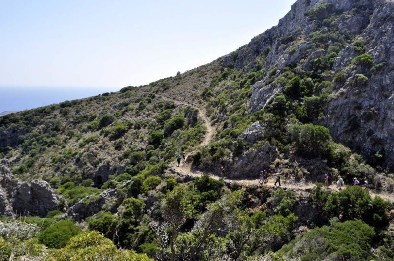 People walking on a visible trail on the island of Kythera